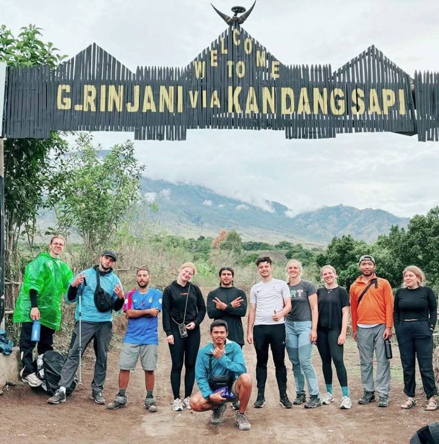Zainal's trekking group under the welcome arch at the Sembalun gate of Rinjani National Park