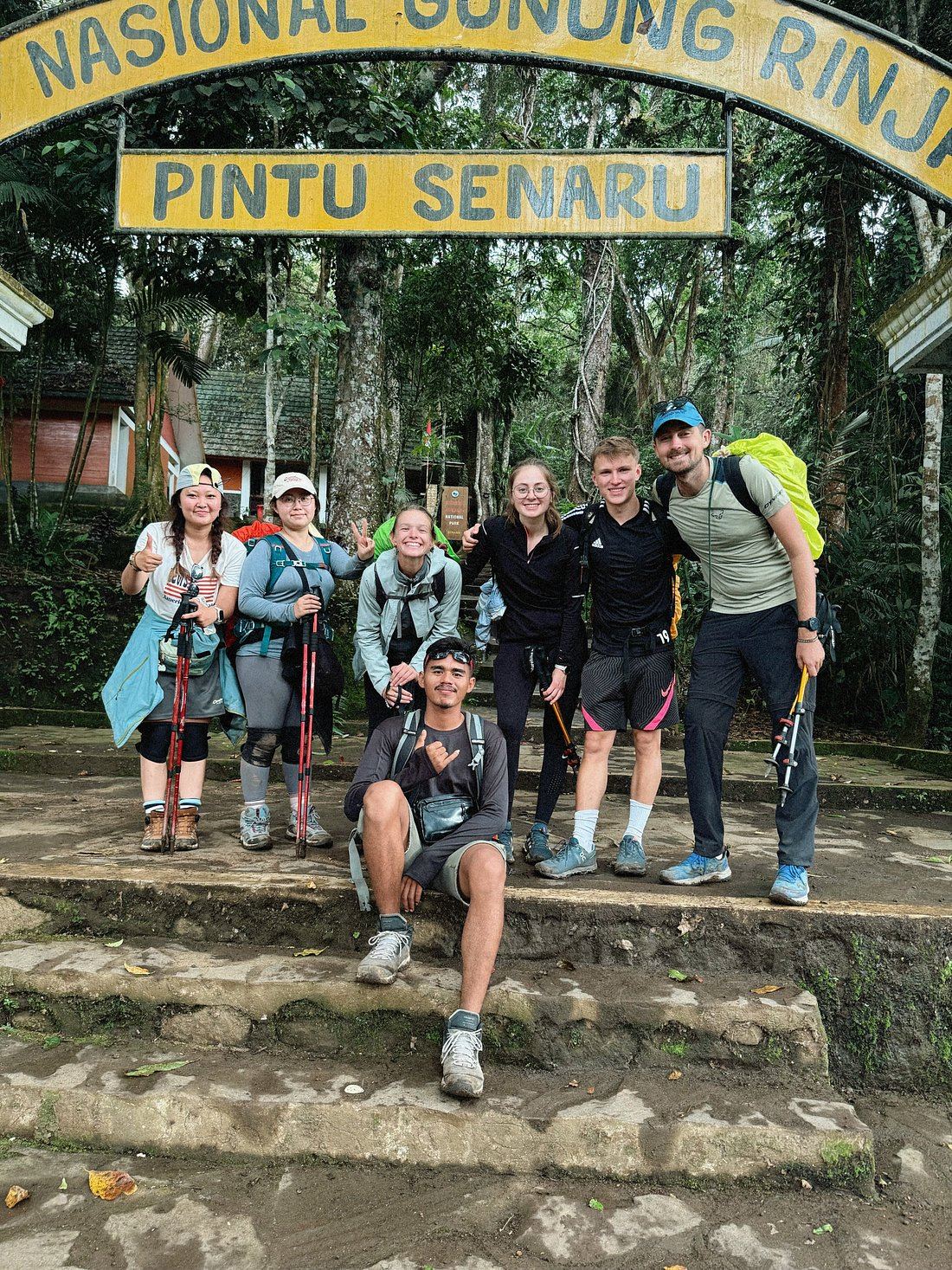 A small trekking group with their guide at the Pintu Senaru national park gate on Mount Rinjani