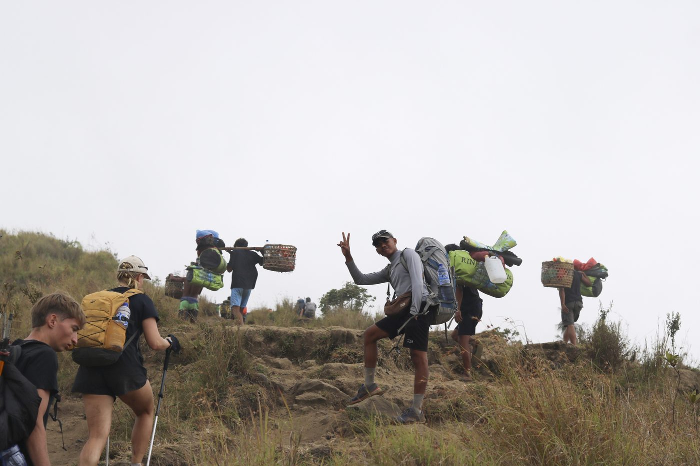Porters carrying loads along the trail out of the caldera