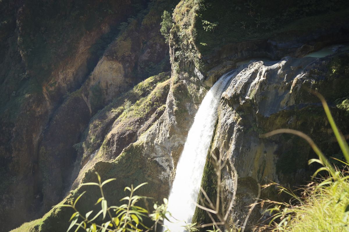 A waterfall plunging into the green Torean gorge